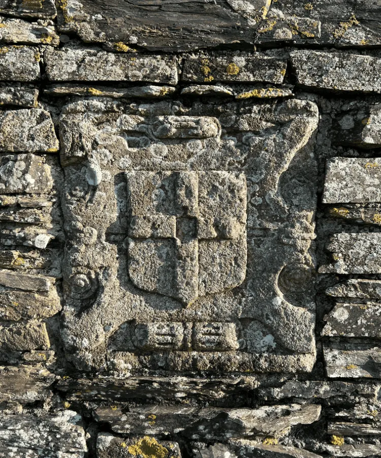 A cross emblem carved into the stone of the medieval chapel at Shillingham farm.